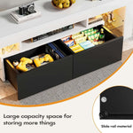 Open black drawers on white TV stand showing storage for games and accessories