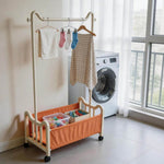 Steel Clothing Rack with Shelves & Wheels for laundry organization in a modern home setting.
