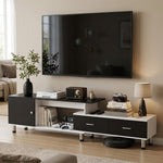 Black and white extendable TV unit beneath a wall-mounted TV in a modern lounge