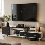 Black and white extendable TV unit beneath a wall-mounted TV in a modern lounge