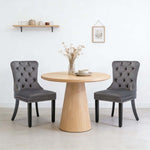 Dining Chairs Set of 2 tufted velvet button-back chairs with nailhead trim around a wooden dining table.