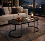 Elegant Oval Black Marble Coffee Table in a modern living room setting with a view.