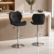 Modern bar stools South Africa in a stylish kitchen setting, featuring sleek black upholstery and chrome accents.