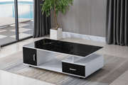 Black marble-top storage coffee table in modern South African living room — white base, cabinet, open shelf and drawer on castors — Artisan SA