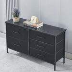 Black dresser with four drawers on a light gray floor against a white wall. | Artisansa SA