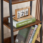 Shelf details with calendar and books on ladder bookshelf with drawer