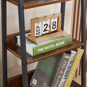 Shelf details with calendar and books on ladder bookshelf with drawer