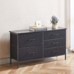 Black dresser with four drawers on a wooden floor against a white wall. | Artisansa SA