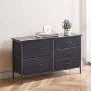 Black dresser with four drawers on a wooden floor against a white wall. | Artisansa SA