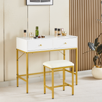 Compact white vanity table with gold frame and stool in a contemporary bedroom