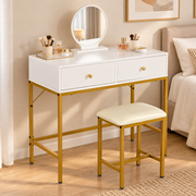 White and gold dressing table set styled with makeup in a modern bedroom