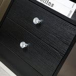 Close-up of the drawer handles on a White Bedside Table with Drawers, showcasing its elegant design and functionality.