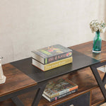 Books stacked on a wooden table with a vase of flowers in the background| Artisansa SA