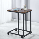 Small wooden table with metal frame and wheels on a white floor.| Artisansa SA