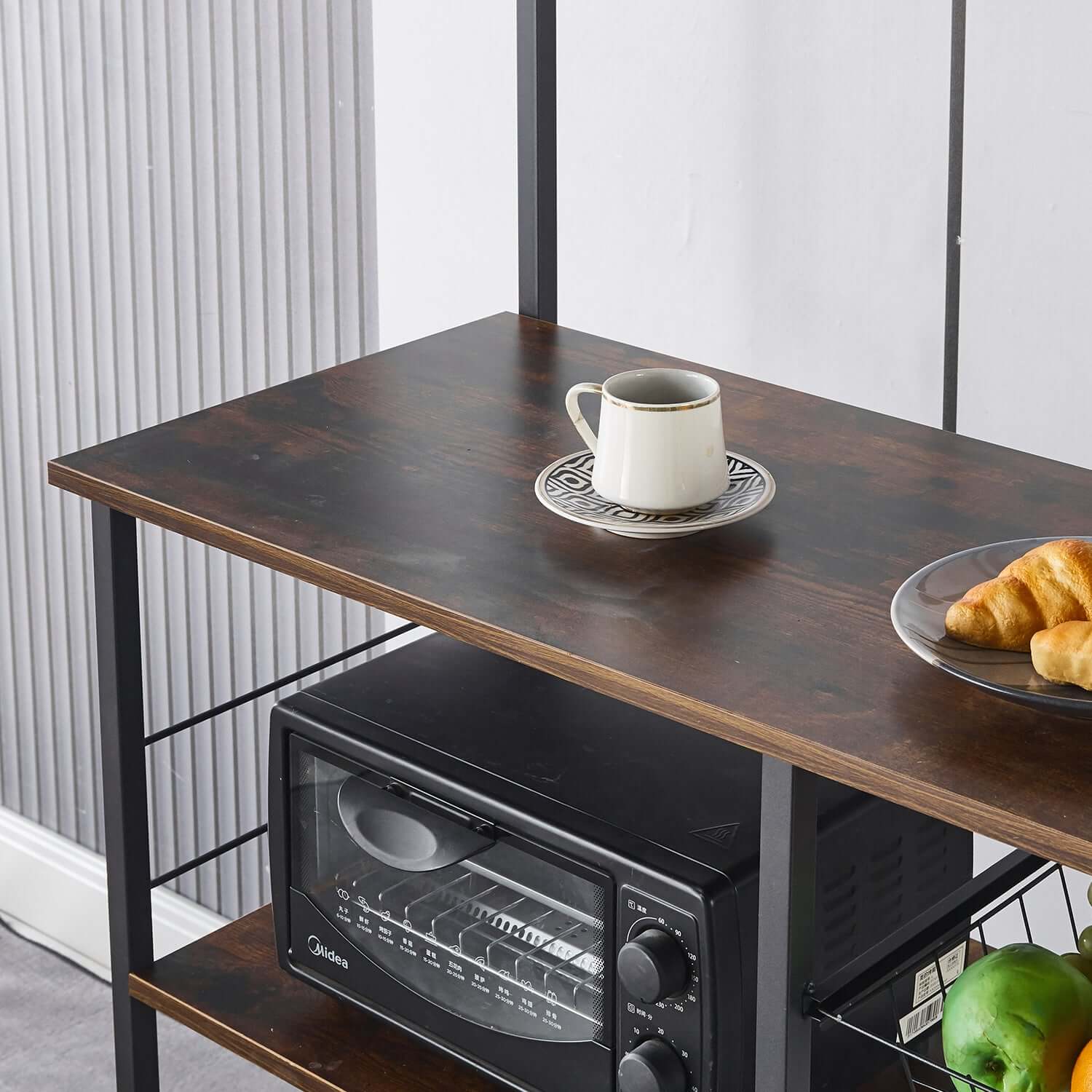 Kitchen Baker's Rack featuring a microwave, coffee cup, and croissants on the top shelf.