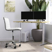Adjustable bar stool set in a modern workspace with dual monitors and potted plant backdrop.