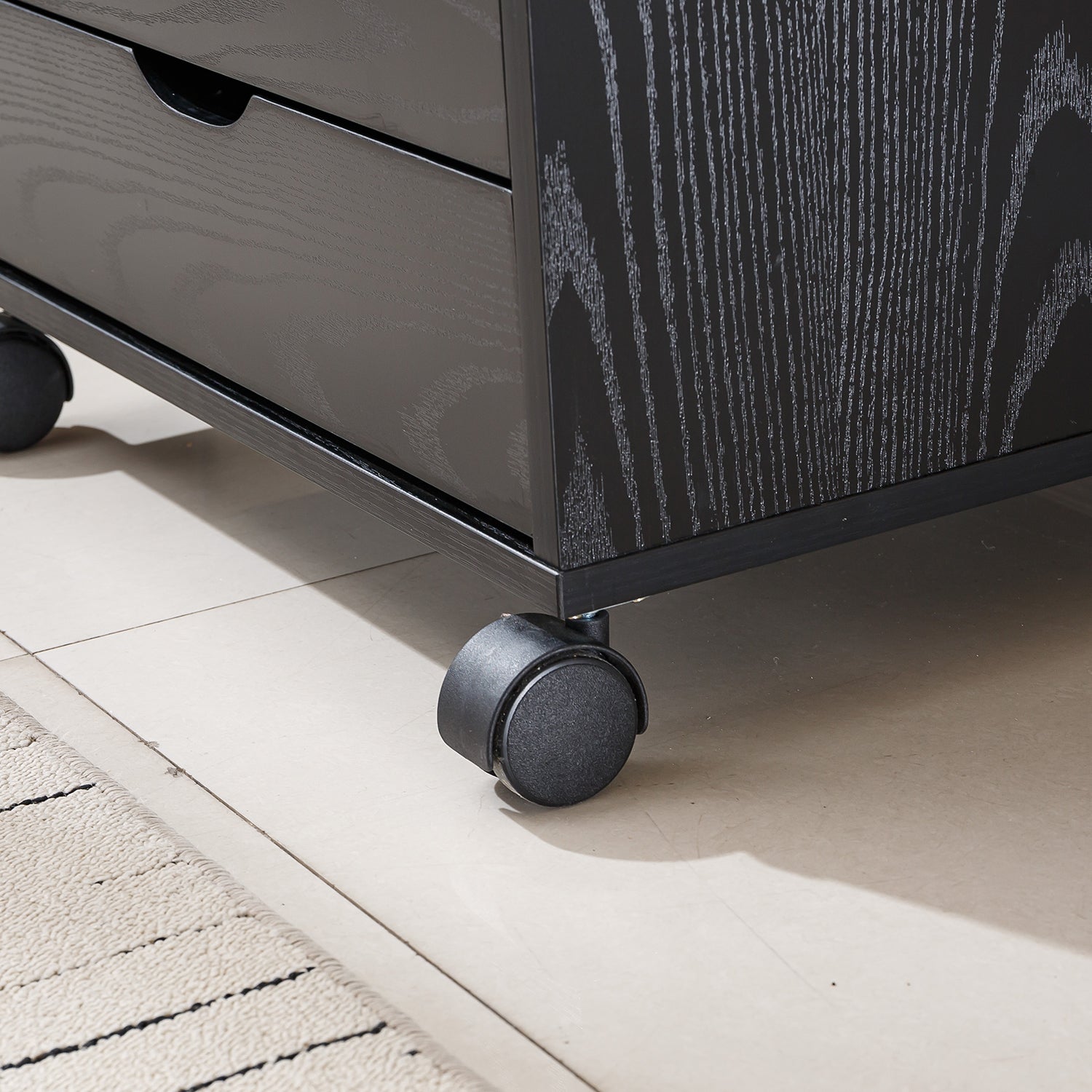 Close-up of Black Bedside Table with Drawers on wheels, showcasing its stylish design and functional storage.