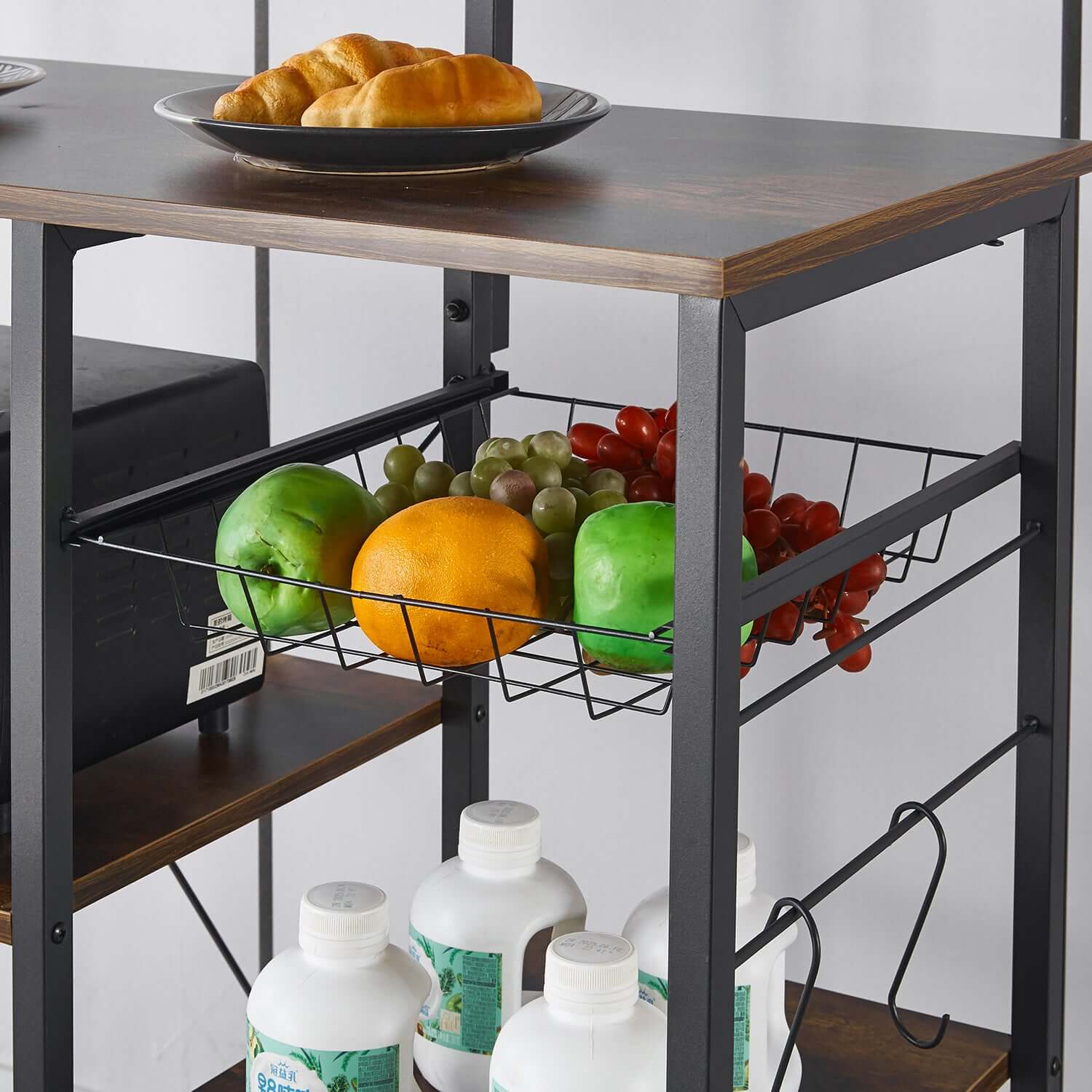 Kitchen Baker's Rack featuring a wire basket filled with fruits and bottles, perfect for kitchen organization.