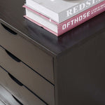 Top view of a Black Bedside Table with Drawers, featuring books stacked on top.