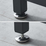 Close-up of a black furniture leg with a silver metal cap on a concrete floor.