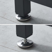 Close-up of a black furniture leg with a silver metal cap on a concrete floor.