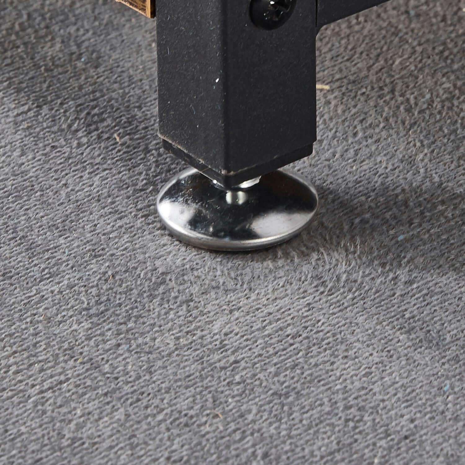 Close-up of the adjustable foot of a Kitchen Baker's Rack, providing stability on various surfaces.