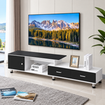 Extended black and white TV stand with storage drawers and open shelf in a bright lounge
