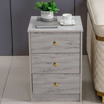 Modern 3-Drawer Side Table with elegant grey finish and gold accents, featuring three drawers and decorative items.