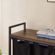 3-Compartment Laundry Sorter with Wood Shelf featuring neatly folded clothes on top.