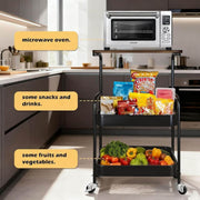 3-Tier Rolling Storage Cart with Wood Top displaying a microwave, snacks, drinks, fruits, and vegetables in a modern kitchen setting.