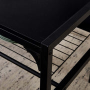 Close-up view of dining table set with bench, featuring black metal frame and storage racks.