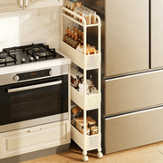 4-Tier Rolling Storage Cart with bottles and jars in a modern kitchen setting, space-saving design next to stove.