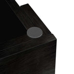 Close-up of a black textured surface with a circular metallic object on a white background| Artisansa SA