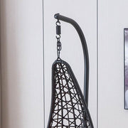 Black woven hammock swing chair F95 against a light gray wall | Artisansa SA