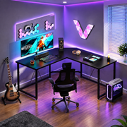 Modern black corner computer desk with raised monitor shelf and spacious workspace
