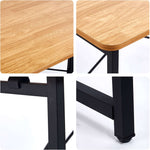 Close-up of the Minimalist Computer Desk showing wood grain surface and X-frame design details.
