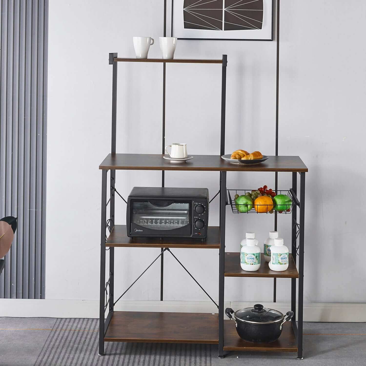 Kitchen Baker's Rack with microwave stand, wire basket, and organized shelves in a modern kitchen setting.