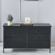 Black dresser with decorative items on a gray wall background | Artisansa SA