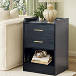 Black bedside table with gold handles styled beside a cream sofa