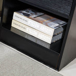 Black bedside table open shelf with books and spacious storage area