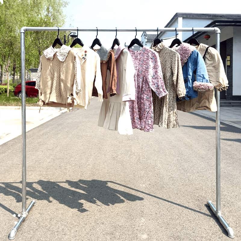 Double clothes rack CDR-02 with various garments outdoors on a sunny day | Artisansa SA