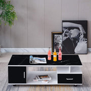 Modern black and white coffee table with drinks and a magazine in a living room setting. | Artisansa SA