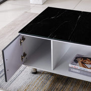 Coffee table with black marble top and open shelf displaying a magazine. | Artisansa SA