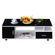 Black marble top coffee table with fruit bowl and decor items on a white background | Artisansa SA