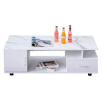 White marble-patterned coffee table with magazines and bottles on a white background | Artisansa SA