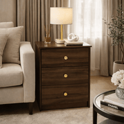 Modern 3-Drawer Nightstand with Gold Handles beside a sofa, featuring a lamp and stylish decor.