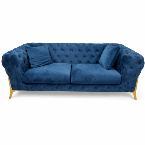 Velvet Chesterfield Sofa in deep blue with tufted design and two pillows, showcasing elegant craftsmanship.