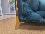 Close-up of Velvet Chesterfield Sofa showcasing elegant deep button tufting and gold metallic legs.