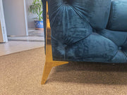 Close-up of Velvet Chesterfield Sofa showcasing elegant deep button tufting and gold metallic legs.