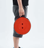 Person holding red circular bag with smiley face design - retractable telescopic foot stool KJ-01 storage bag | Artisansa SA